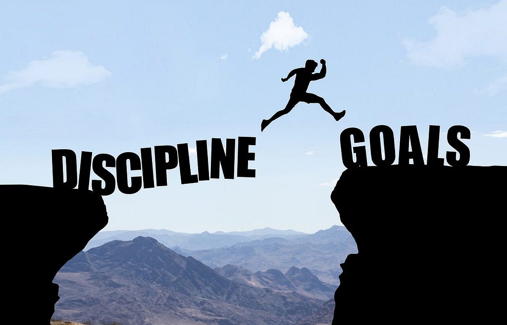 Discipline and goals: person jumping across a gap